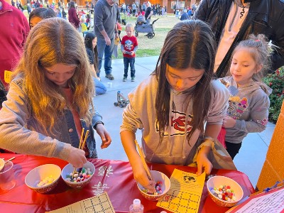  Photo of students learning to use chopsticks